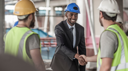 construction-manager-in-suit-shaking-hands-with-workers